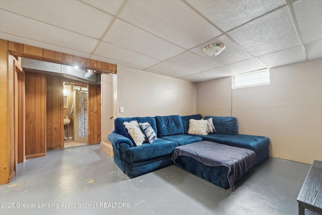 536 Hunter Blvd, Lansing, MI 48910 - living room with a paneled ceiling, concrete flooring, and wood walls