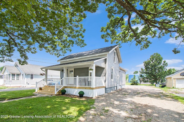 304 W Gibbs St, Saint Johns, MI 48879 - view of front of property featuring a porch, a front yard, and a shingled roof