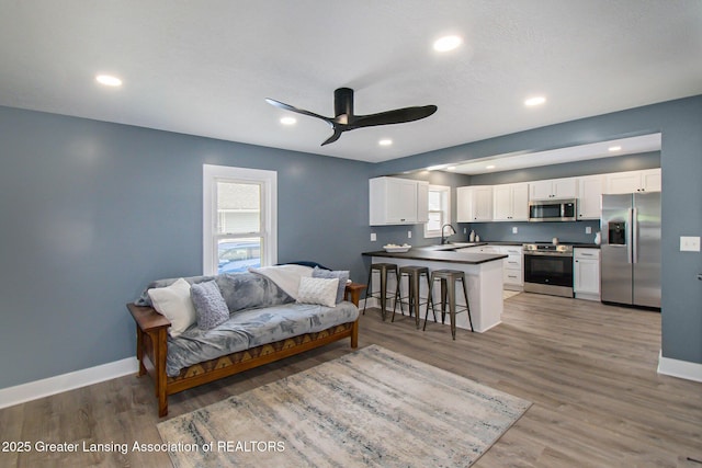 304 W Gibbs St, Saint Johns, MI 48879 - living room with a ceiling fan, light wood-type flooring, and recessed lighting