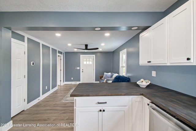 304 W Gibbs St, Saint Johns, MI 48879 - kitchen featuring dishwasher, a peninsula, wood finished floors, white cabinets, and a ceiling fan