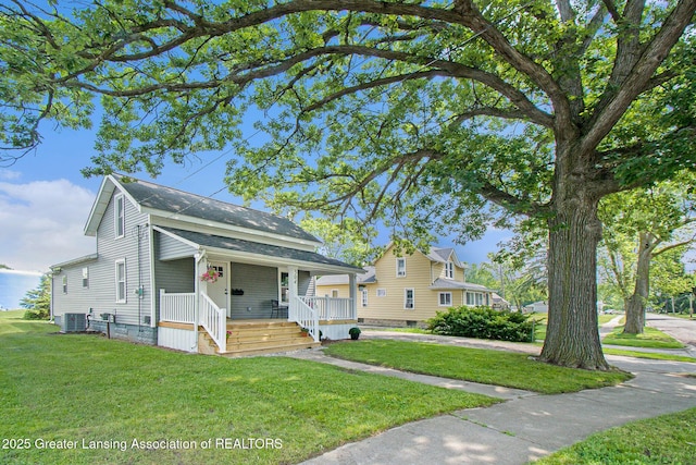 304 W Gibbs St, Saint Johns, MI 48879 - view of front facade featuring a porch, a front yard, and a shingled roof