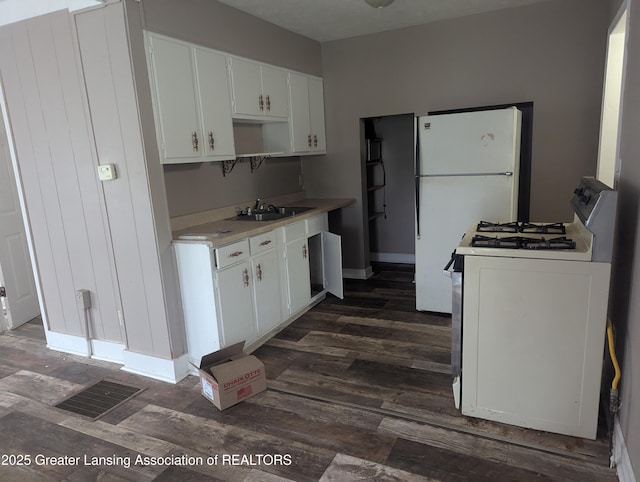 527 S Charles St, Lansing, MI 48912 - kitchen featuring white appliances, dark wood-type flooring, light countertops, and white cabinets