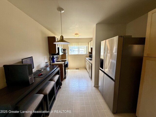 3618 Alpine Dr, Lansing, MI 48911 - kitchen with stainless steel fridge with ice dispenser, range with electric cooktop, and hanging light fixtures