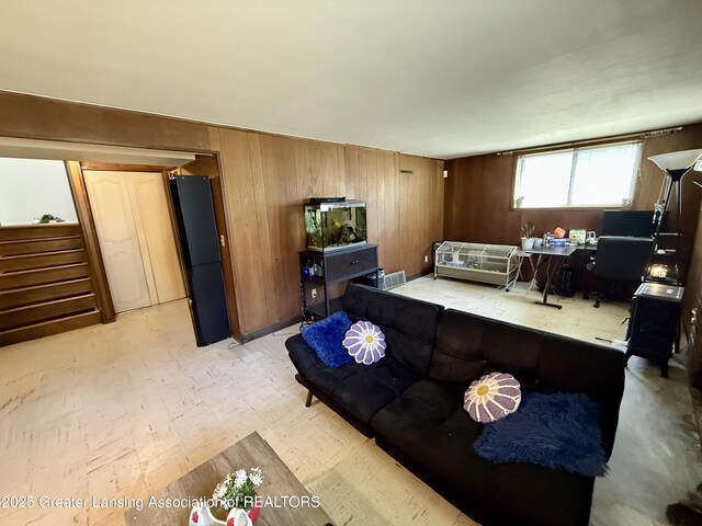 3618 Alpine Dr, Lansing, MI 48911 - living area featuring wooden walls, light flooring, and stairway