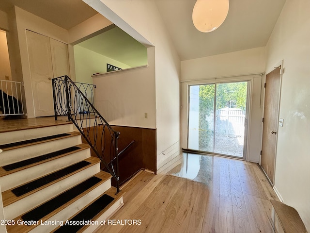3618 Alpine Dr, Lansing, MI 48911 - entrance foyer featuring wood finished floors, stairway, and a wainscoted wall