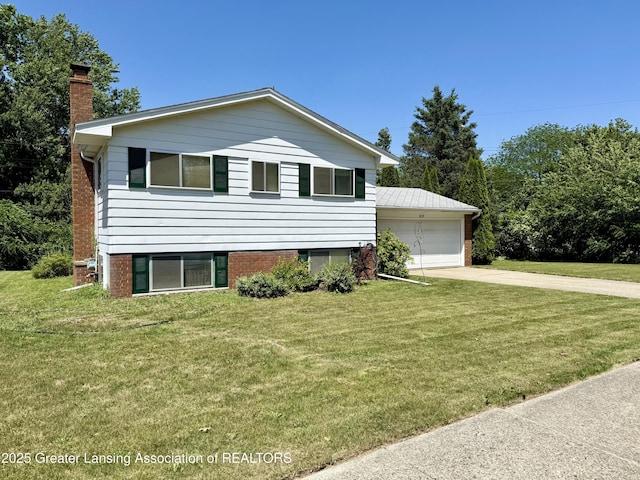 3618 Alpine Dr, Lansing, MI 48911 - split level home with a chimney, an outbuilding, a front yard, and a garage