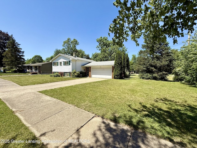 3618 Alpine Dr, Lansing, MI 48911 - split level home with a garage, a front lawn, and concrete driveway