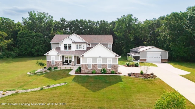 9655 Tobermory Dr, Haslett, MI 48840 - craftsman-style home with stone siding, an outdoor structure, a detached garage, driveway, and a front lawn