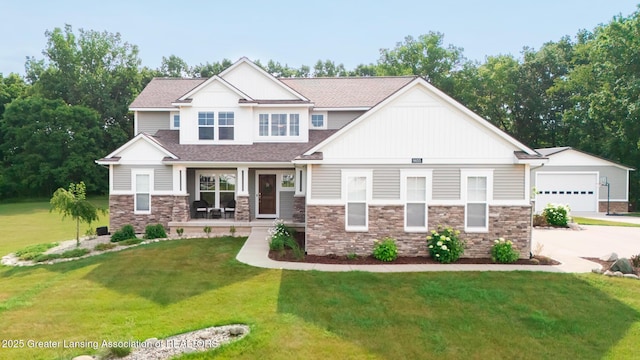 9655 Tobermory Dr, Haslett, MI 48840 - craftsman-style house featuring stone siding, a front yard, covered porch, and a garage