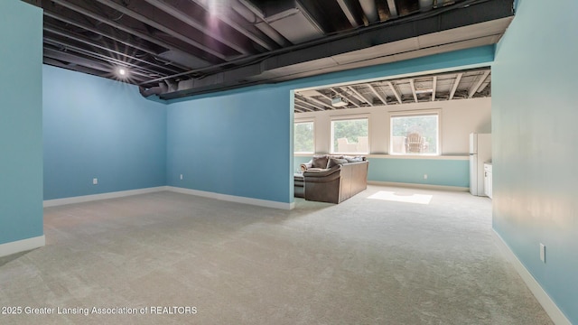 9655 Tobermory Dr, Haslett, MI 48840 - below grade area with carpet floors and freestanding refrigerator