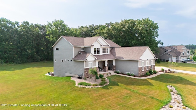 9655 Tobermory Dr, Haslett, MI 48840 - craftsman house featuring a front lawn, stone siding, covered porch, and roof with shingles