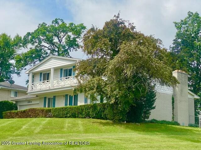 12906 Bilmar Ln, Grand Blanc, MI 48439 - view of front facade with a balcony, a front lawn, and a chimney