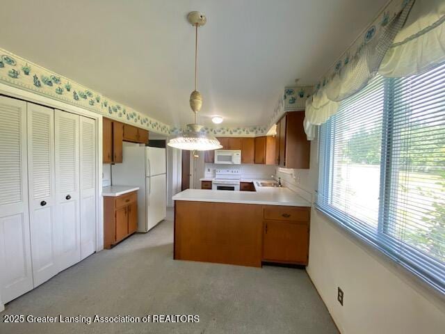 12906 Bilmar Ln, Grand Blanc, MI 48439 - kitchen featuring white appliances, light countertops, and healthy amount of natural light