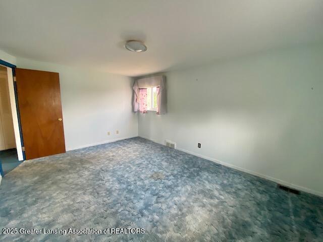12906 Bilmar Ln, Grand Blanc, MI 48439 - unfurnished bedroom featuring carpet and a barn door