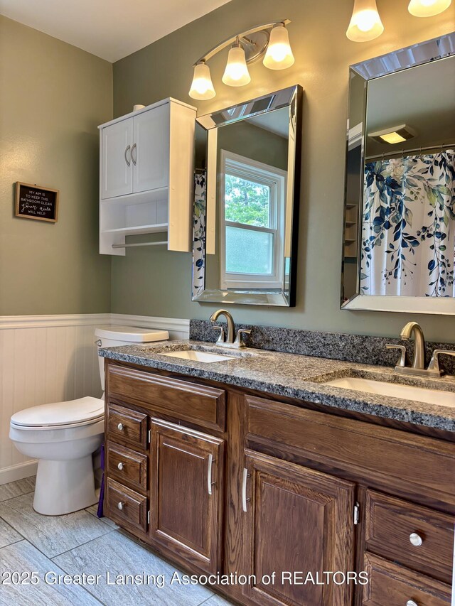 1023 E Colonial Park Dr, Grand Ledge, MI 48837 - bathroom with double vanity and wainscoting