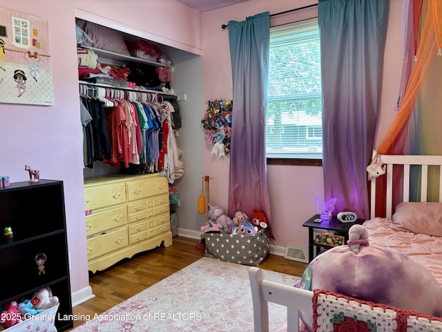 1023 E Colonial Park Dr, Grand Ledge, MI 48837 - bedroom featuring wood finished floors and a closet
