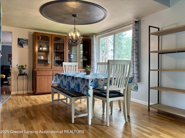 1023 E Colonial Park Dr, Grand Ledge, MI 48837 - dining space featuring a chandelier and light wood-type flooring