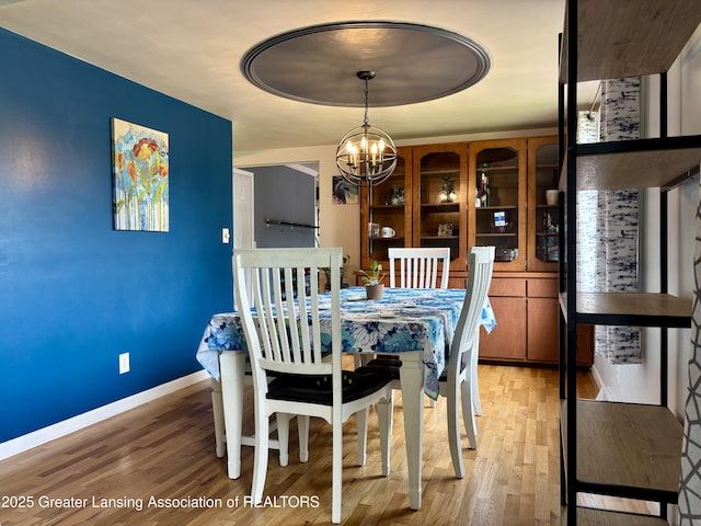 1023 E Colonial Park Dr, Grand Ledge, MI 48837 - dining space featuring a chandelier and wood finished floors
