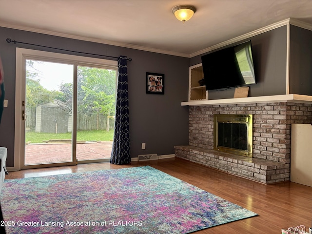 1023 E Colonial Park Dr, Grand Ledge, MI 48837 - living area with ornamental molding, wood finished floors, and a fireplace