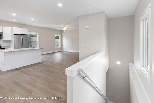 1635 Pattengill Ave, Lansing, MI 48910 - kitchen with freestanding refrigerator, white cabinets, recessed lighting, ceiling fan, and light wood-type flooring