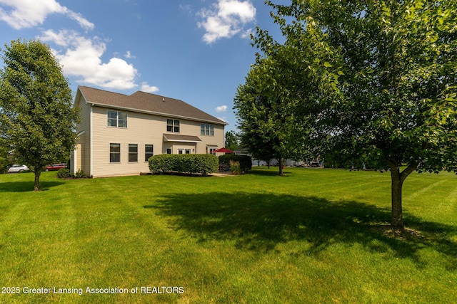 6075 Sacramento Way E, Lansing, MI 48823 - rear view of property with a lawn