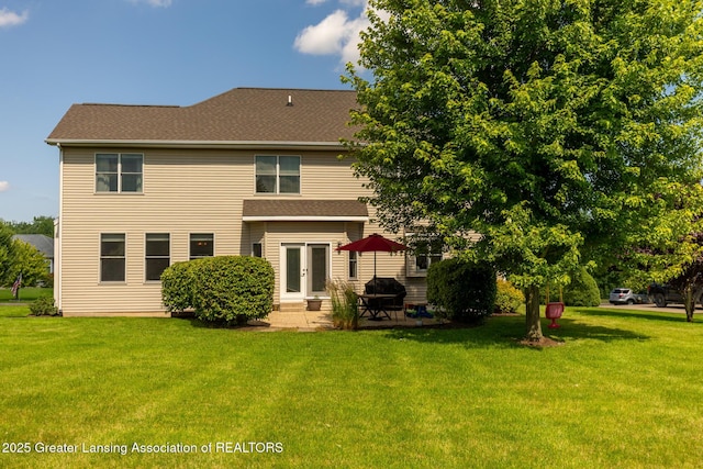 6075 Sacramento Way E, Lansing, MI 48823 - back of property featuring a yard, a patio, and roof with shingles