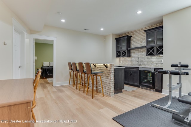 6075 Sacramento Way E, Lansing, MI 48823 - indoor dry bar featuring wine cooler, light wood finished floors, and recessed lighting