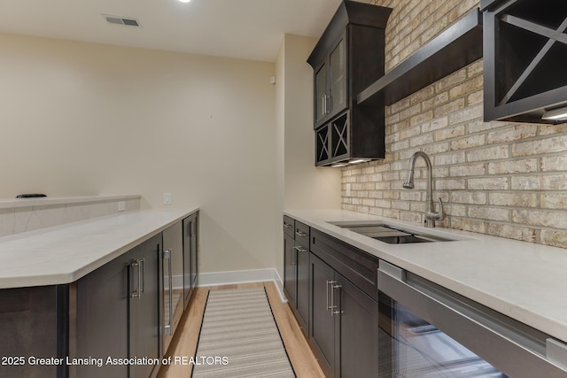 6075 Sacramento Way E, Lansing, MI 48823 - kitchen featuring light wood finished floors, light countertops, dishwasher, tasteful backsplash, and a peninsula