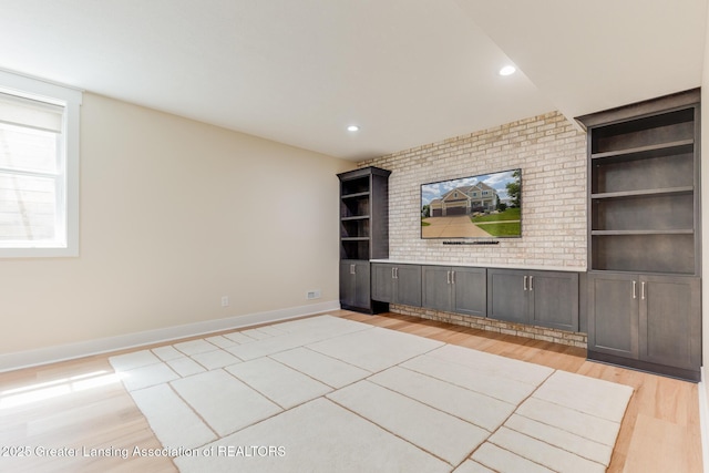6075 Sacramento Way E, Lansing, MI 48823 - unfurnished living room featuring light wood finished floors, built in shelves, and recessed lighting