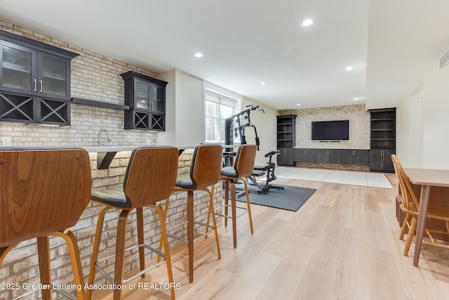 6075 Sacramento Way E, Lansing, MI 48823 - community bar area featuring light wood-style flooring, a brick fireplace, and recessed lighting