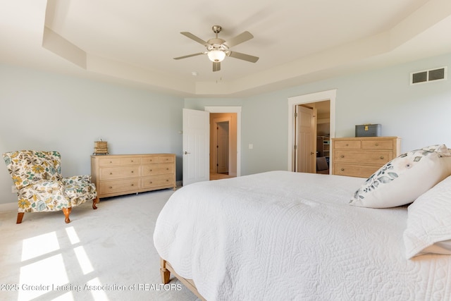 6075 Sacramento Way E, Lansing, MI 48823 - bedroom featuring light colored carpet, a raised ceiling, and a ceiling fan