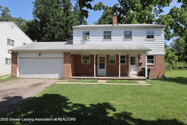3700-3702 Malibu Dr, Lansing, MI 48911 - view of front facade featuring a chimney, brick siding, asphalt driveway, and covered porch