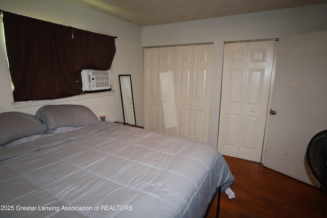 3700-3702 Malibu Dr, Lansing, MI 48911 - bedroom with cooling unit, multiple closets, and wood finished floors