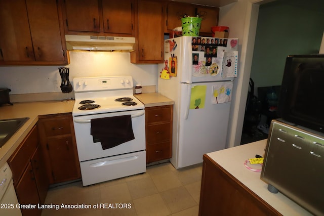 3700-3702 Malibu Dr, Lansing, MI 48911 - kitchen featuring white appliances, under cabinet range hood, light countertops, and brown cabinetry