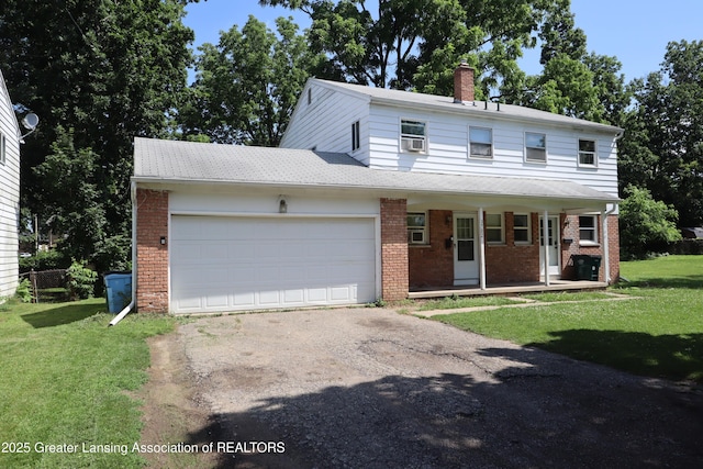 3700-3702 Malibu Dr, Lansing, MI 48911 - view of front of house with brick siding, asphalt driveway, and a garage