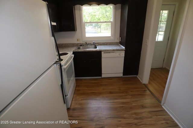 3700-3702 Malibu Dr, Lansing, MI 48911 - kitchen with white appliances, wood finished floors, and plenty of natural light