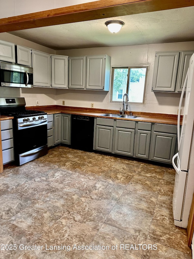 1115 Rose Ave, Big Rapids, MI 49307 - kitchen with appliances with stainless steel finishes and gray cabinets