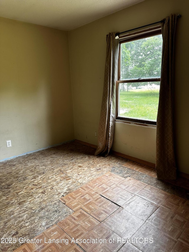1115 Rose Ave, Big Rapids, MI 49307 - unfurnished room featuring baseboards