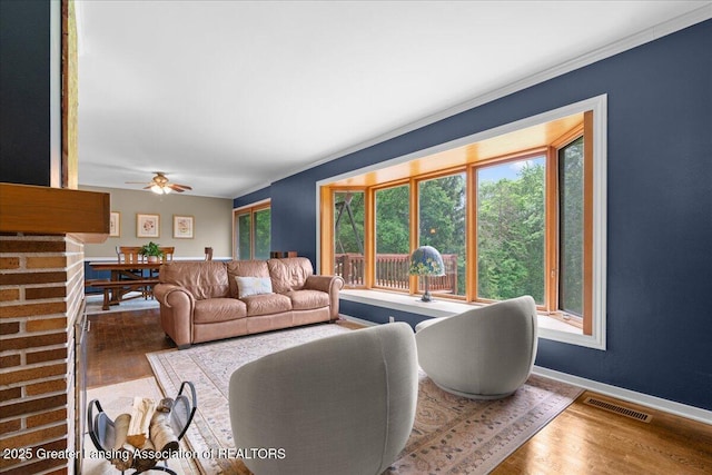 1395 Biscayne Way, Haslett, MI 48840 - living room with wood finished floors, ornamental molding, and ceiling fan