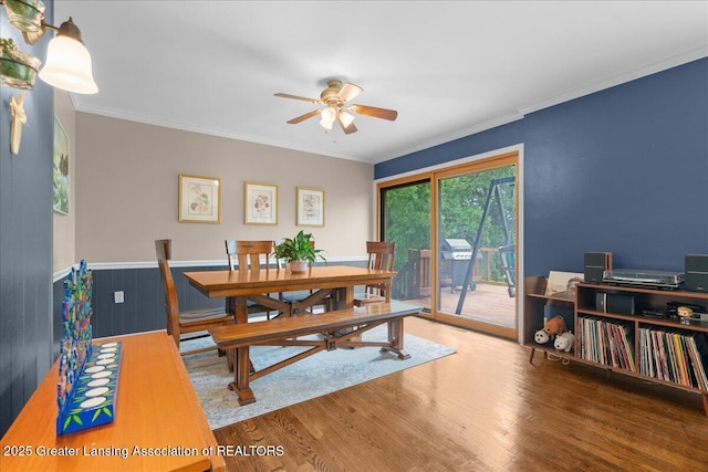 1395 Biscayne Way, Haslett, MI 48840 - dining room featuring ceiling fan, wood finished floors, crown molding, and a wainscoted wall