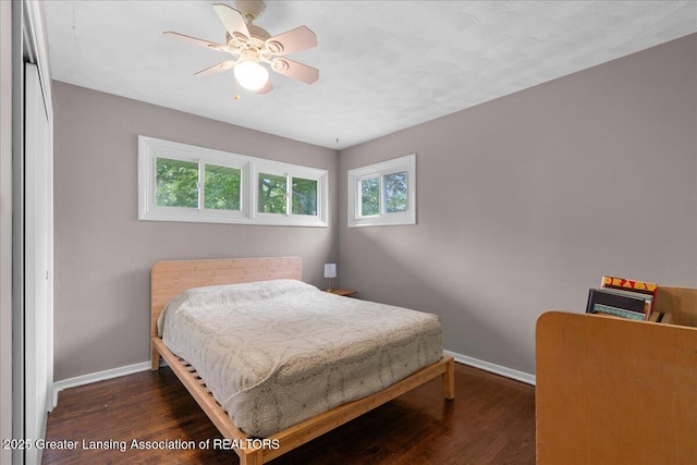 1395 Biscayne Way, Haslett, MI 48840 - bedroom featuring multiple windows, dark wood-style flooring, and a ceiling fan