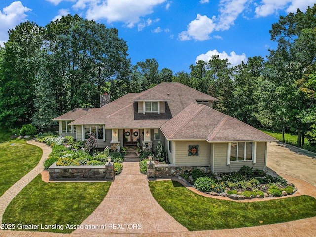 10696 W Clark Rd, Eagle, MI 48822 - traditional-style house featuring roof with shingles, a front yard, a chimney, and covered porch