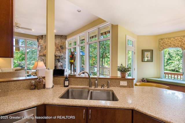 10696 W Clark Rd, Eagle, MI 48822 - kitchen with plenty of natural light, light stone countertops, and a ceiling fan