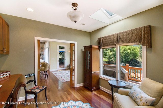 10696 W Clark Rd, Eagle, MI 48822 - living room featuring a skylight and wood finished floors