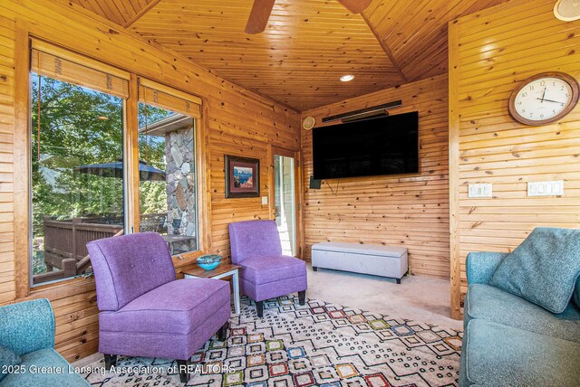 10696 W Clark Rd, Eagle, MI 48822 - carpeted living room with wood walls, a ceiling fan, and wood ceiling