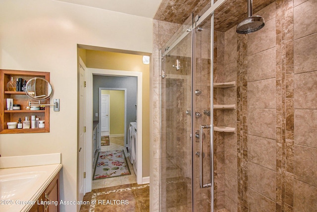 10696 W Clark Rd, Eagle, MI 48822 - bathroom featuring independent washer and dryer, a stall shower, vanity, and tile patterned flooring