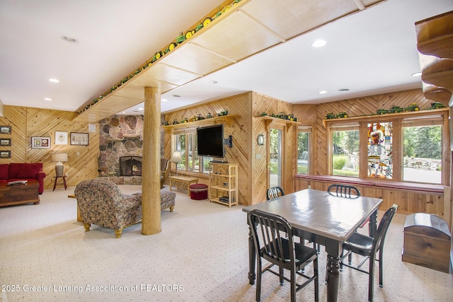 10696 W Clark Rd, Eagle, MI 48822 - dining space featuring wooden walls, carpet, recessed lighting, a fireplace, and ornate columns