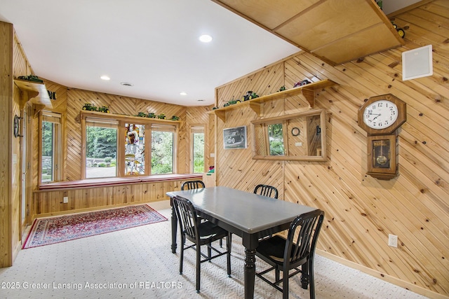 10696 W Clark Rd, Eagle, MI 48822 - dining space with wood walls, recessed lighting, and carpet flooring