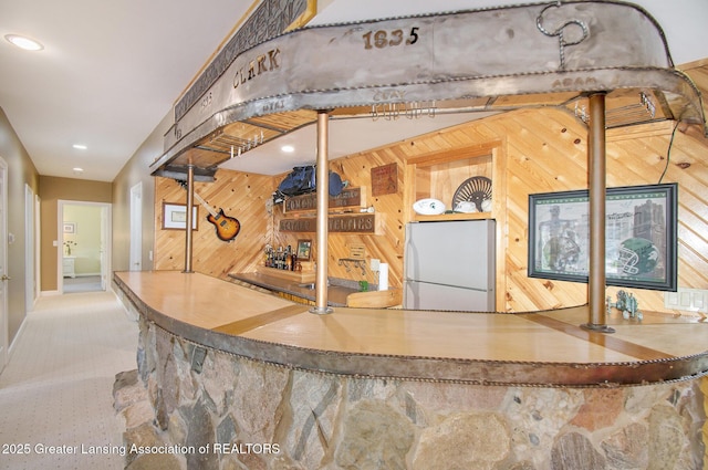 10696 W Clark Rd, Eagle, MI 48822 - indoor bar with freestanding refrigerator, wood walls, and recessed lighting