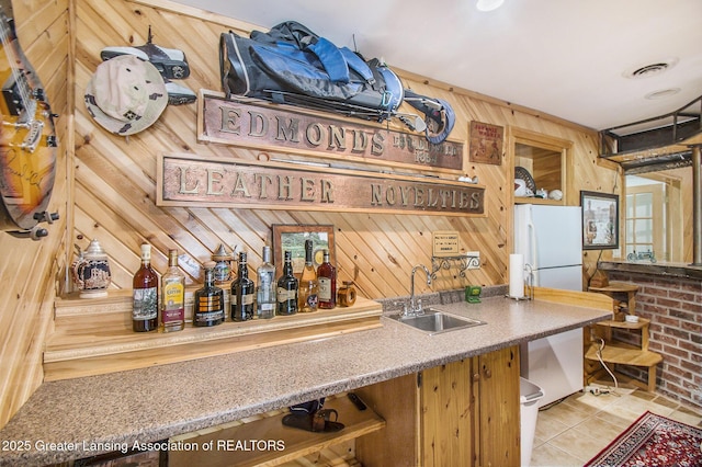 10696 W Clark Rd, Eagle, MI 48822 - indoor wet bar with freestanding refrigerator, wood walls, and light tile patterned floors
